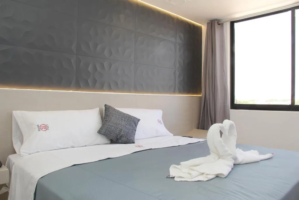 Cama King en una habitación de Hotel Parador Real